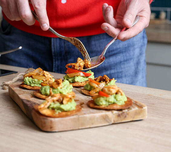 Tasty sharers or starters for a Latin feast, fajita chicken and guacamole on a crisp oven baked tostada.